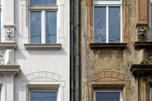 Renovated vs. not renovated townhouse facade illustrates urban building contrast.